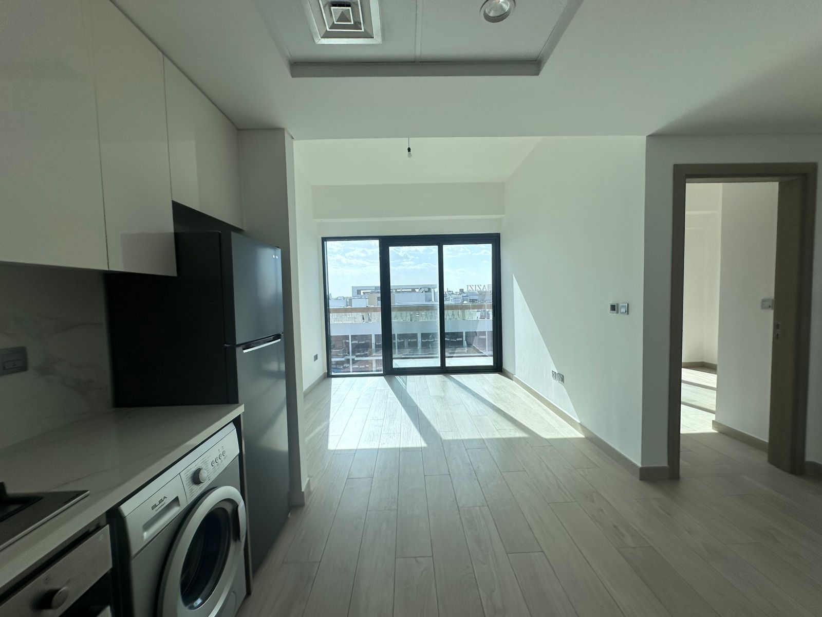 The apartment features an open kitchen fitted with built-in appliances