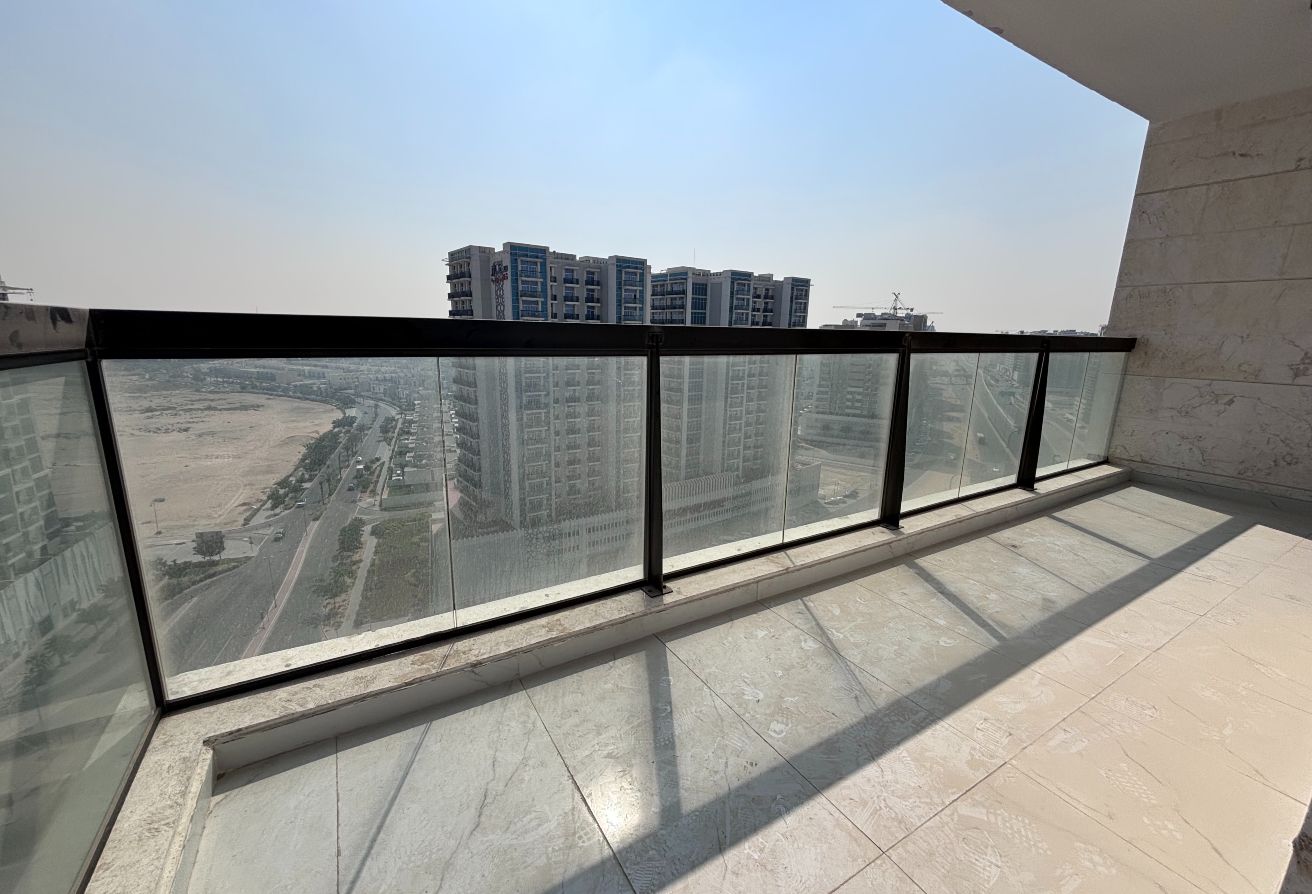The apartment features an open-plan kitchen leading to a bright living room