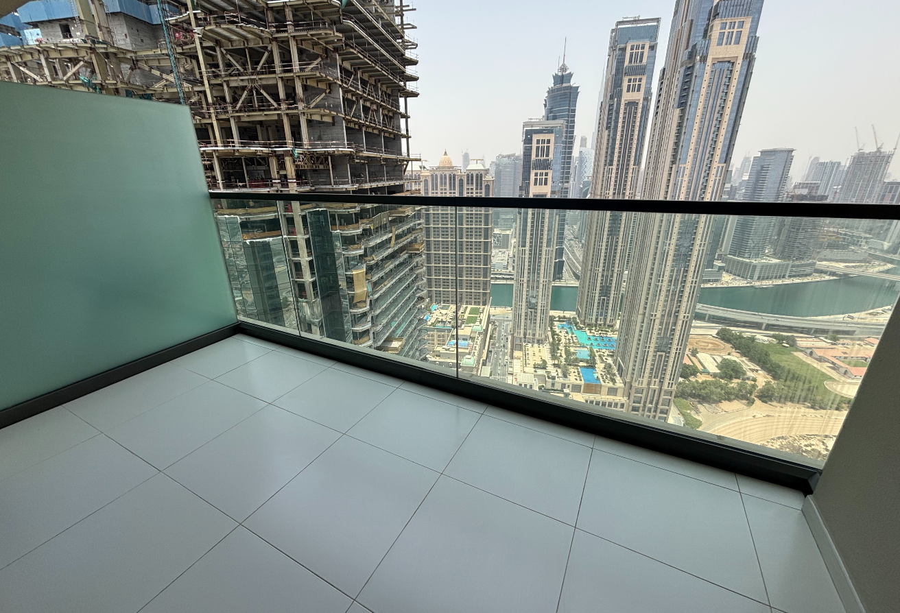 -Cozy bedroom with built-in wardrobes and large windows showcasing stunning views