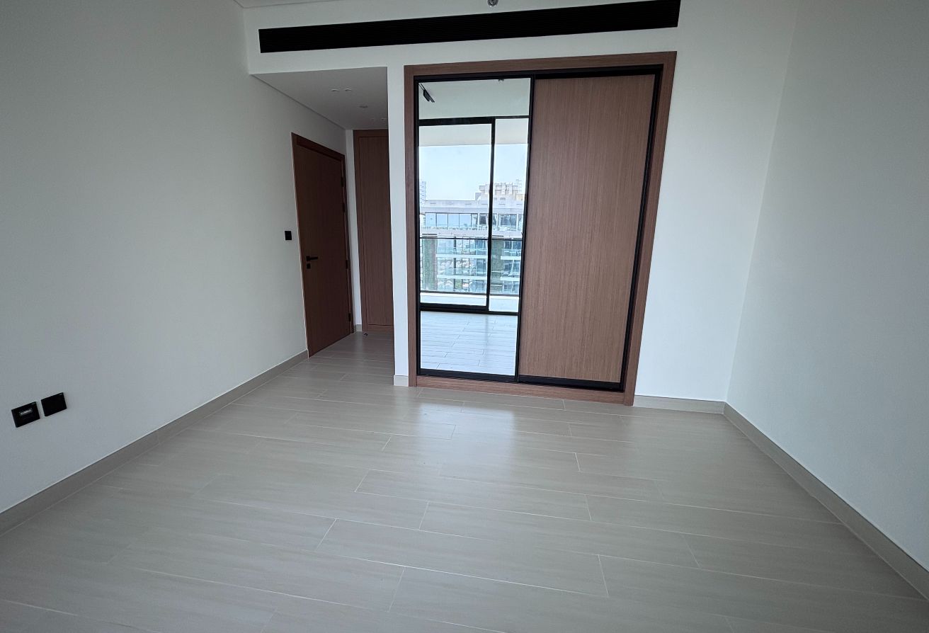 creating a seamless indoor-outdoor flow. The unit offers a guest bathroom